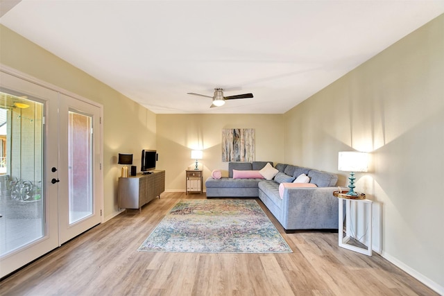 living room featuring french doors, ceiling fan, light hardwood / wood-style flooring, and a wealth of natural light