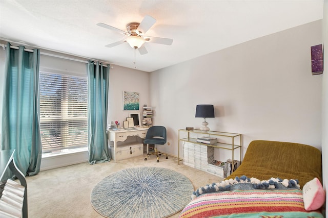 office area with ceiling fan and carpet flooring