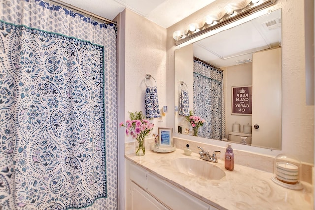 bathroom featuring vanity, curtained shower, and toilet