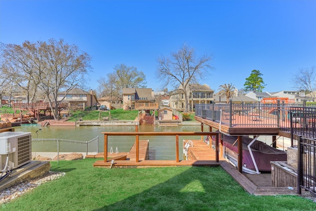 view of yard with cooling unit, a residential view, a wooden deck, and fence