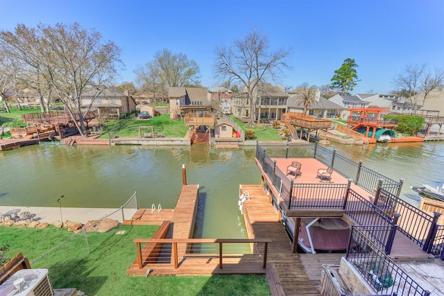 view of dock with central AC, a water view, and a residential view