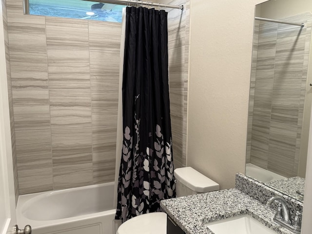 full bathroom with shower / tub combo, vanity, and toilet