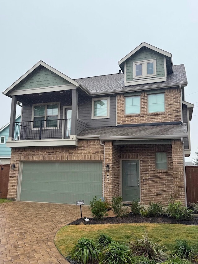 view of front facade featuring a garage and a balcony