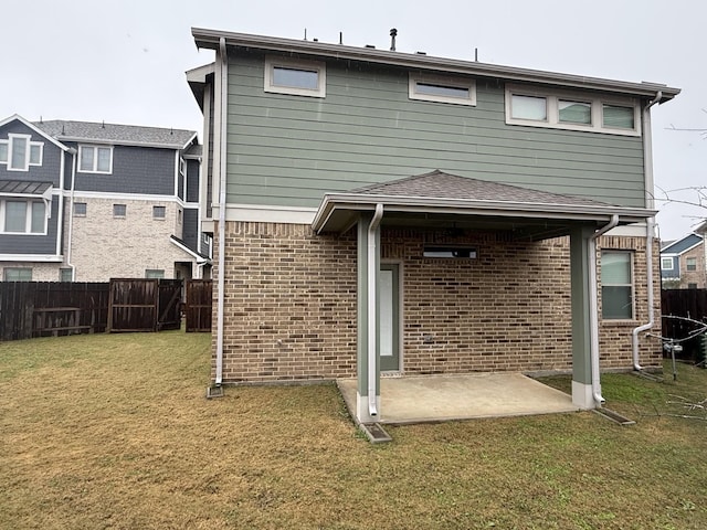 rear view of property featuring a patio and a yard