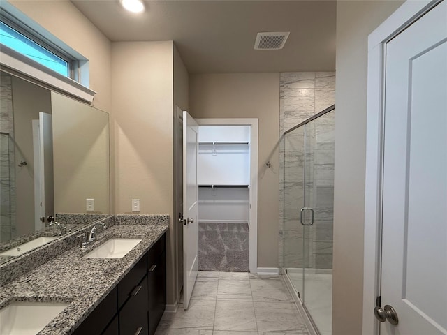 bathroom with walk in shower and vanity