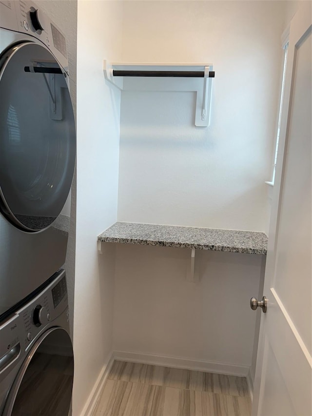 clothes washing area with stacked washer and clothes dryer