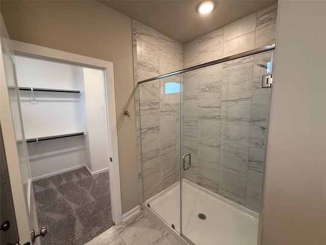 bathroom featuring a shower with shower door