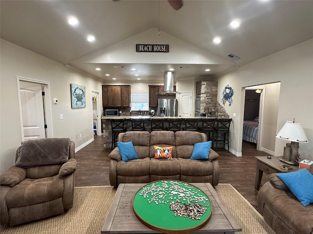 living room with hardwood / wood-style flooring and high vaulted ceiling