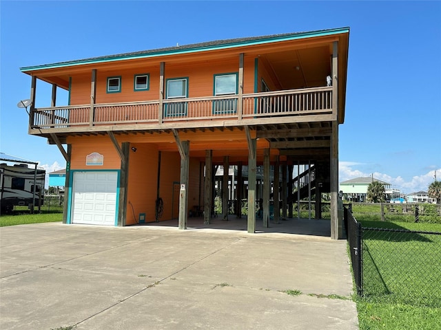 view of front of home featuring a garage, a balcony, and a carport