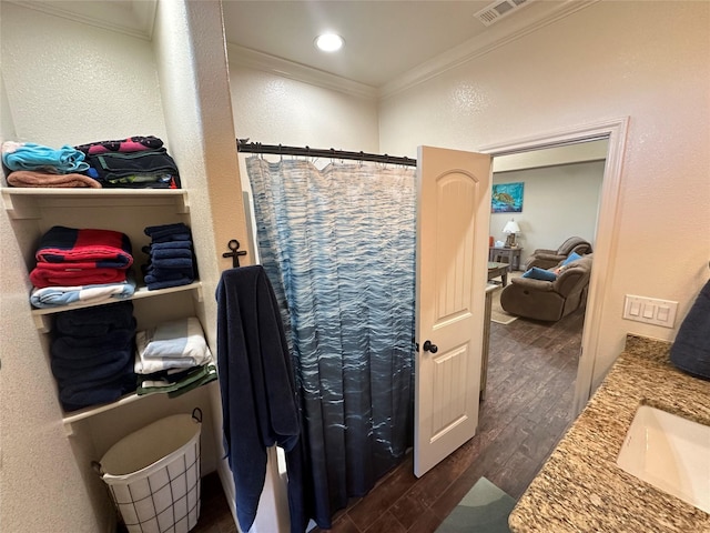 bathroom featuring vanity, hardwood / wood-style floors, ornamental molding, and a shower with shower curtain