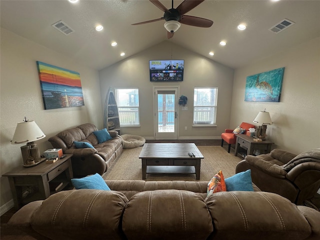 living room featuring a wealth of natural light, ceiling fan, and vaulted ceiling