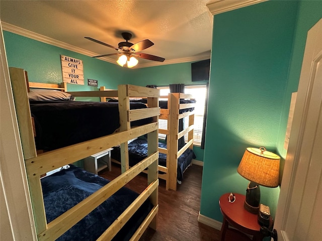 bedroom featuring ornamental molding, dark wood-type flooring, ceiling fan, and a textured ceiling