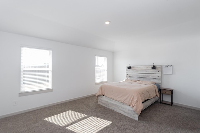 bedroom with dark colored carpet