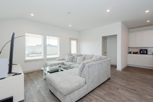 living room featuring lofted ceiling and light wood-type flooring