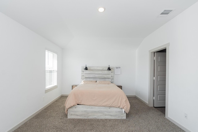 carpeted bedroom with lofted ceiling