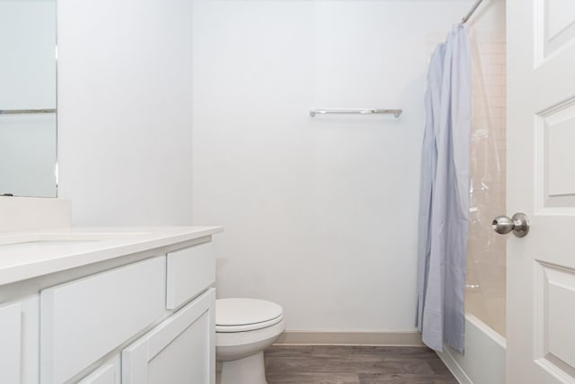 full bathroom with vanity, hardwood / wood-style flooring, shower / bath combination with curtain, and toilet