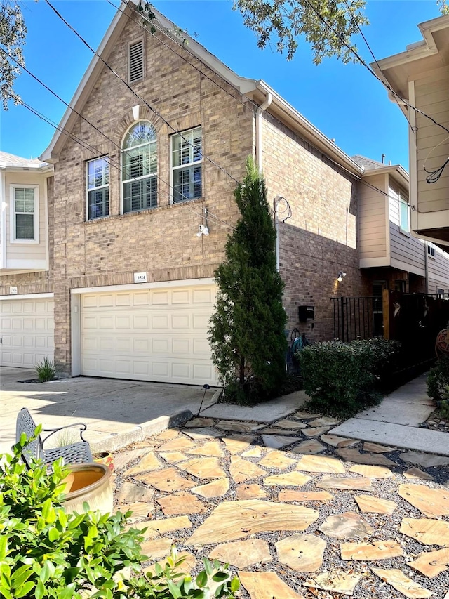 view of side of property featuring concrete driveway, brick siding, and an attached garage