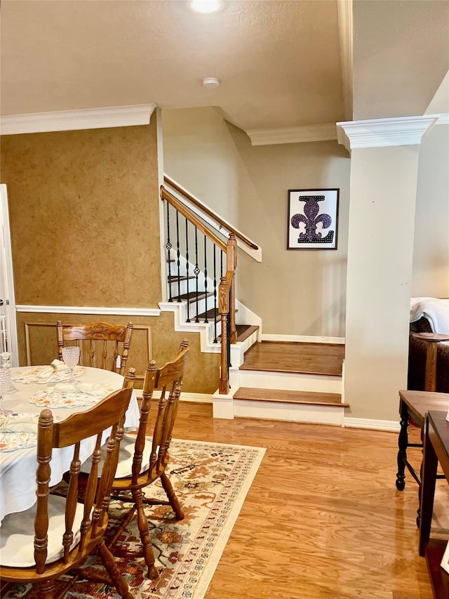 interior space featuring ornamental molding, stairway, baseboards, and wood finished floors