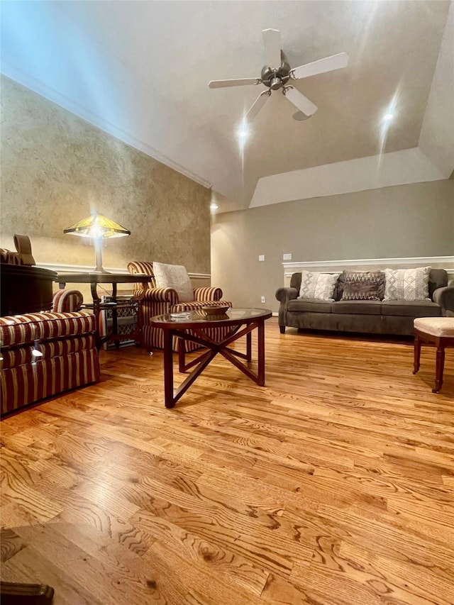 interior space with light wood finished floors, vaulted ceiling, and a ceiling fan