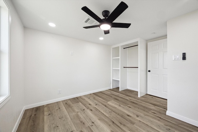 unfurnished bedroom featuring light hardwood / wood-style floors, a closet, and ceiling fan