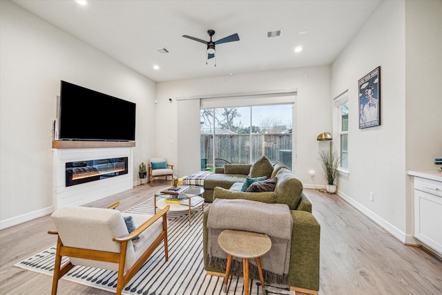 living room with ceiling fan and light hardwood / wood-style floors