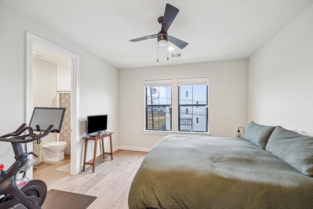 bedroom featuring ensuite bath, light hardwood / wood-style flooring, and ceiling fan