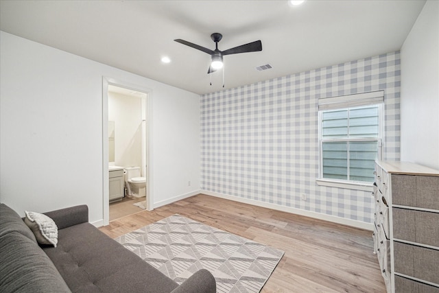 living room featuring ceiling fan and light wood-type flooring