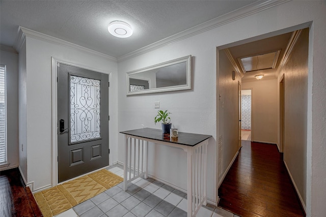 foyer entrance with crown molding, a wealth of natural light, and a textured ceiling