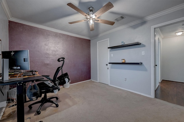 unfurnished office with ceiling fan, ornamental molding, and light carpet