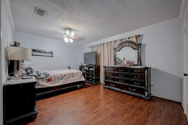 bedroom with wood-type flooring, ceiling fan, a textured ceiling, and crown molding