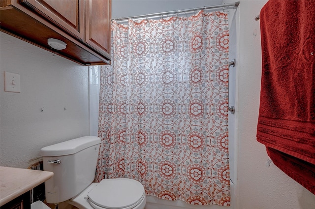 bathroom featuring vanity, curtained shower, and toilet