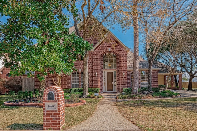 english style home with a front lawn