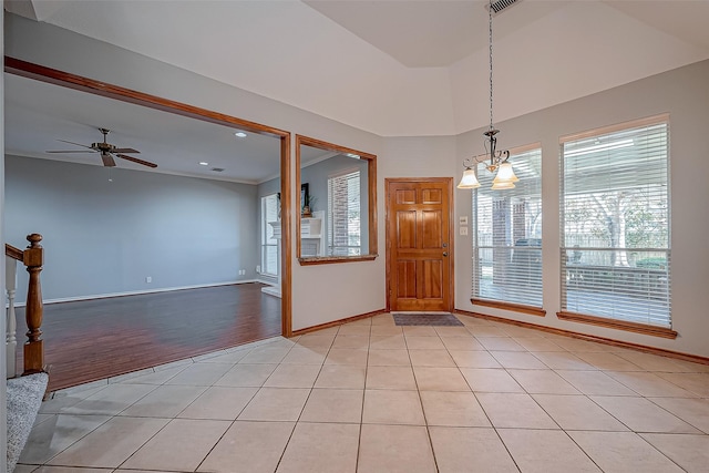 empty room with ceiling fan and light tile patterned floors