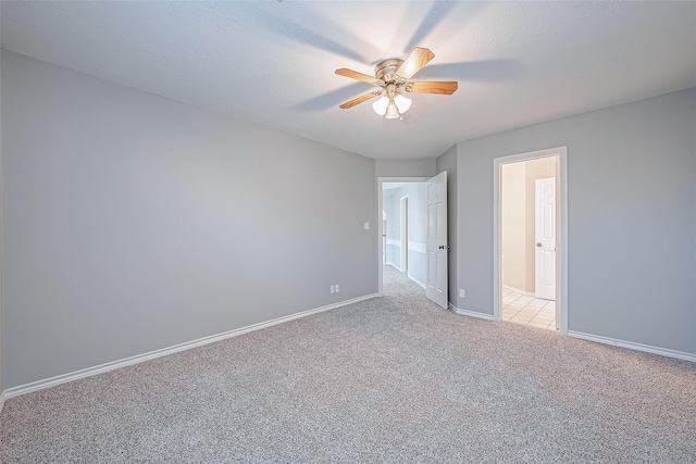 spare room with light carpet and ceiling fan