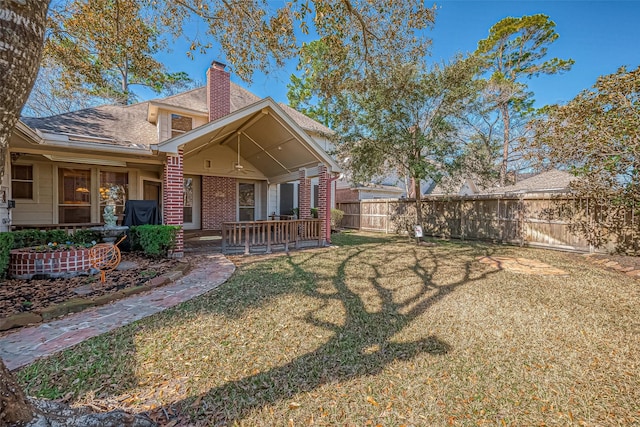 back of house with a yard and a patio area