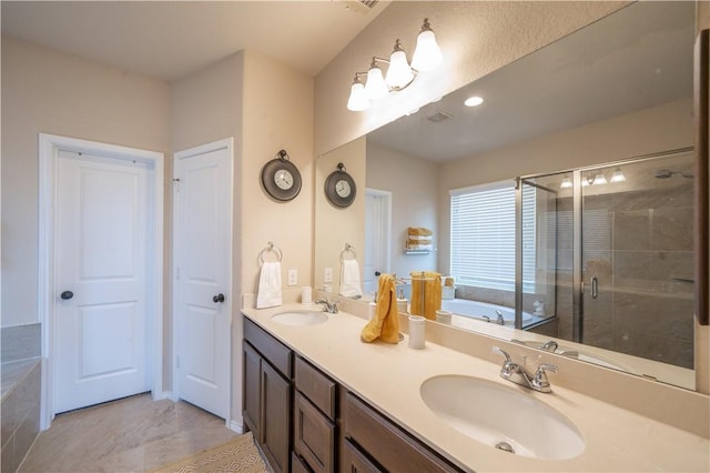 bathroom with vanity and separate shower and tub