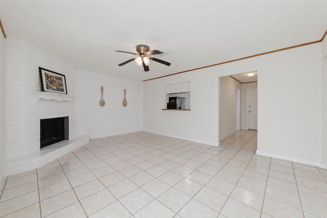 unfurnished living room featuring ceiling fan, crown molding, light tile patterned flooring, and a fireplace