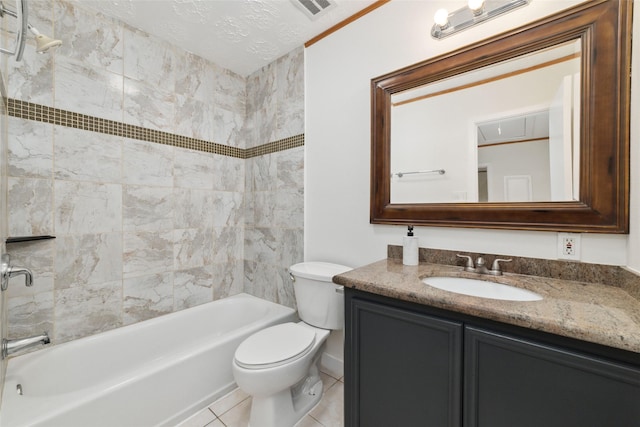 full bathroom with vanity, a textured ceiling, tiled shower / bath, tile patterned floors, and toilet