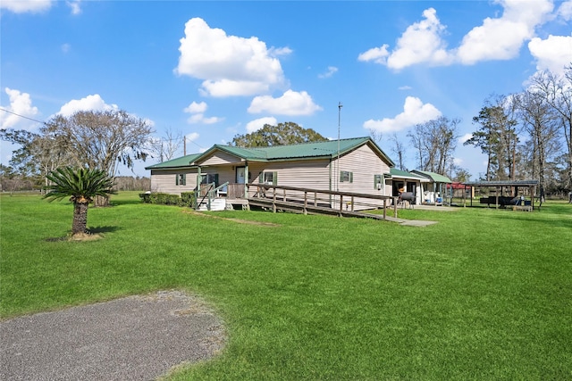 exterior space with a yard, a carport, and a deck