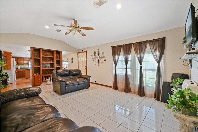 tiled living room featuring vaulted ceiling and ceiling fan