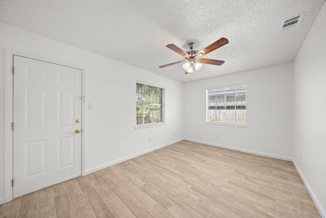 unfurnished room featuring ceiling fan, a textured ceiling, and light wood-type flooring