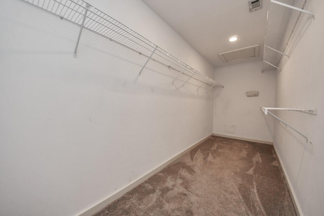 spacious closet featuring dark carpet