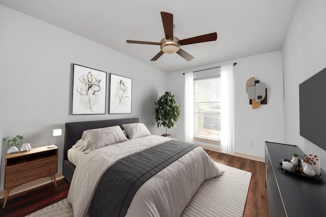 bedroom with dark wood-type flooring and ceiling fan