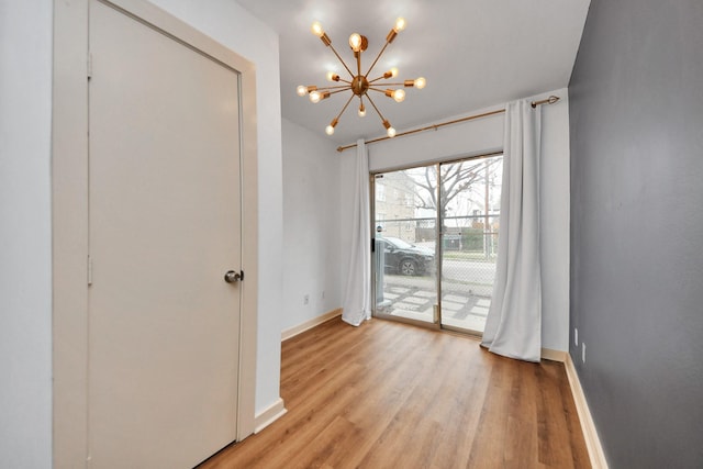 interior space featuring a chandelier and light wood-type flooring