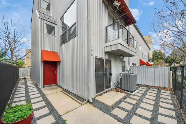 view of side of home featuring central AC unit