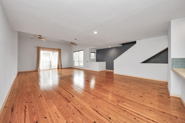 unfurnished living room with ceiling fan and light hardwood / wood-style floors