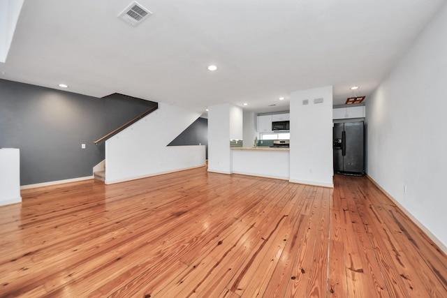 unfurnished living room featuring light hardwood / wood-style flooring