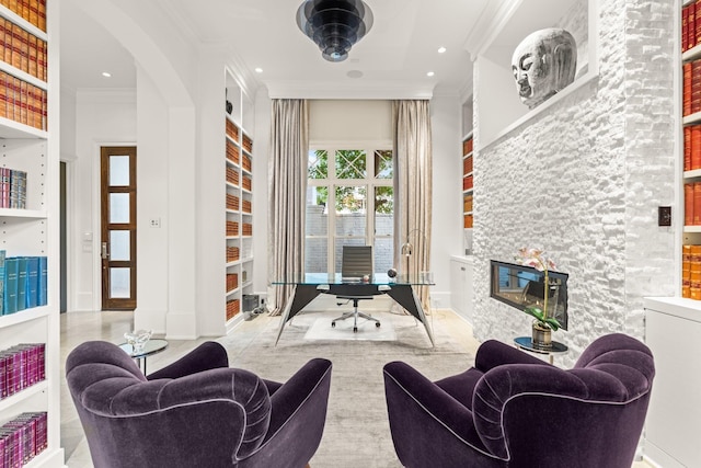 living room featuring crown molding and a stone fireplace