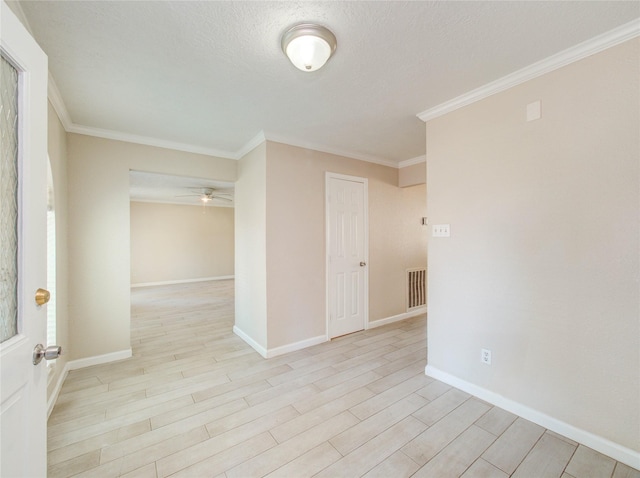 spare room with crown molding, ceiling fan, a textured ceiling, and light hardwood / wood-style floors