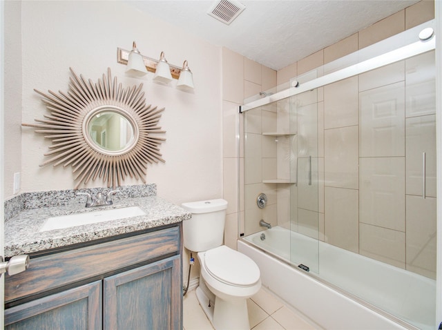 full bathroom with vanity, tile patterned floors, shower / bath combination with glass door, and toilet